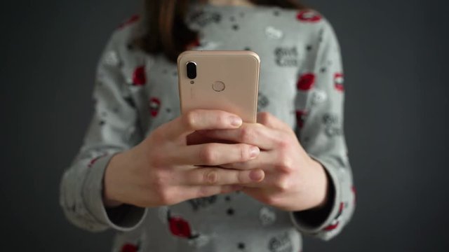 Close up of young teenage girl typing message on smartphone with smartphone text massage animation appearing . Close up female hands. Social network animation. Social media message.