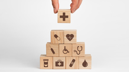 Concept of Insurance for your health, Hand hold wooden block with icon healthcare medical