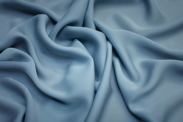Naklejka na ściany i meble Silk fabric. Color is gray-blue. Texture, background, pattern.