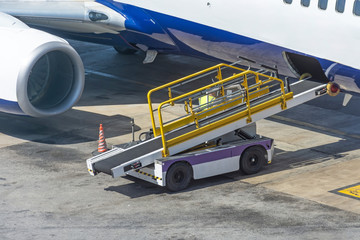Car for loading luggage compartment of the aircraft is ready, waiting for cargo.