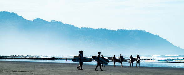 Fototapeta na wymiar Surfers on the beach