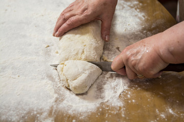 Hands kneading dough for gnocchi.
