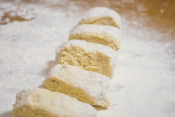 Hands kneading dough for gnocchi.