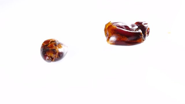 Dried date fruits falling down in slow motion. Healthy food
