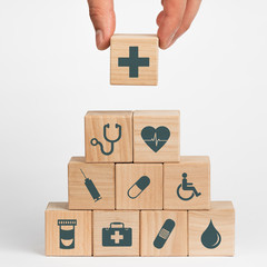 Concept of Insurance for your health, Hand hold wooden block with icon healthcare medical