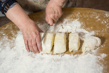 Hands kneading dough for gnocchi.
