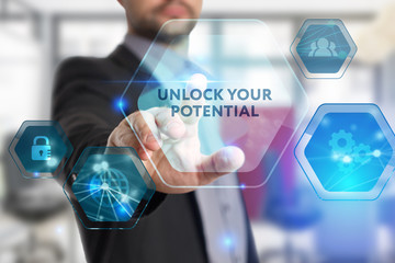 The concept of business, technology, the Internet and the network. A young entrepreneur working on a virtual screen of the future and sees the inscription: Unlock your potential