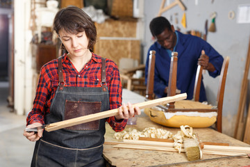 Artisans in process of renewing armchair
