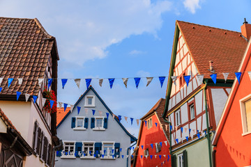 Oktoberfest decoration in the streets of old German town. Street with traditional Houses and...