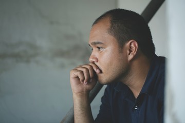 depressed man sitting in dark room