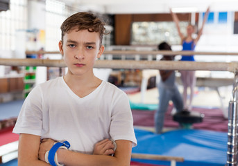 Unhappy tired teenage boy in sportswear