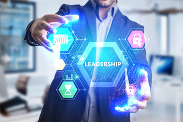 The concept of business, technology, the Internet and the network. A young entrepreneur working on a virtual screen of the future and sees the inscription: Leadership