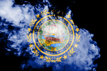 The national flag of the US state New Hampshire in against a gray smoke on the day of independence in different colors of blue red and yellow. Political and religious disputes, customs and delivery.