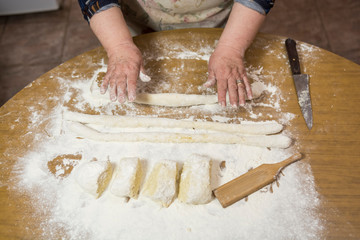 Hands kneading dough for gnocchi.