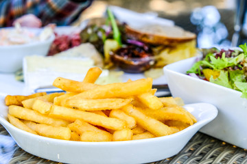 Bowl of Chips or French Fries In a Table Setting Outdoors