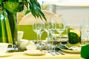 Luxury party dinner table setting with tableware and silverware and glasses set and Candlestick and flower in restaurant.