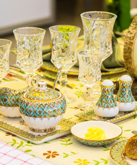 Wedding party dinner table setting with tableware and silverware and glasses set and Candlestick and flower in restaurant.