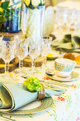 Wedding dinner table setting with tableware and silverware and glasses set and Candlestick and flower in restaurant.