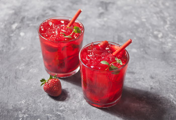 Glasses with fresh homemade strawberry sweet iced tea or cocktail, lemonade with mint. Refreshing cold drink. Summer party.
