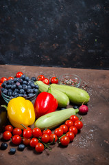 Fresh raw vegetables on dark background.