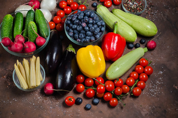 Fresh raw vegetables on dark background.