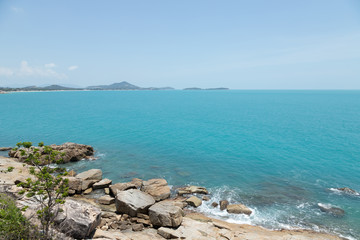 view of sea waves shore and fantastic rocky beach coast on the island and background sky with mountain, Wild nature. Tropical landscape coastline. Summertime. Travel holiday concept.
