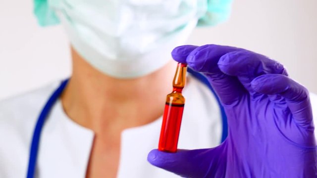 Medicine doctor holding pharmacy ampule