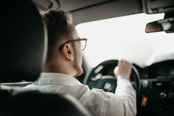 driver businessman rides a business class car through the city in sunglasses. luxury taxi services.