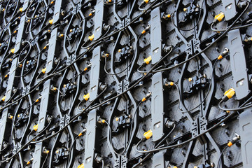 Backside of digital LED panels of large display screen. Large electronic screen with coaxial cables wires, close-up shot, tv screen cables wires