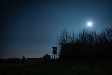Hunter stand in Moonlight at night