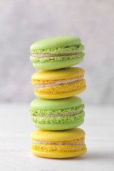 macaroons. delicious colored french macaroni cakes on a white wooden table.