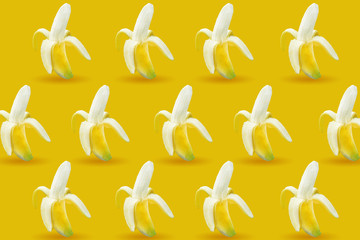 colourful fruit pattern of fresh yellow bananas on colored background