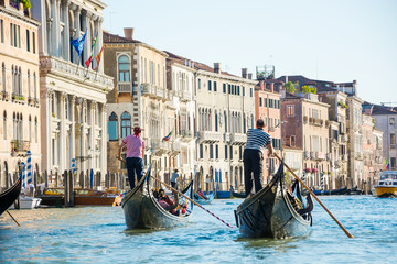 View of the Grand Canal from a gondola in Venice, Italy. Gondoliers on gondolas in Venice © allai