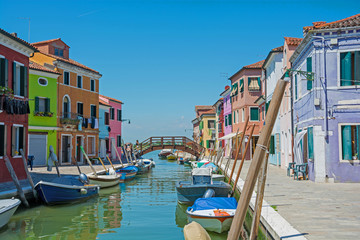 Fototapeta na wymiar Burano island, Italy. View of the colored houses near the canal on the island of Burano, Italy