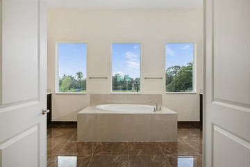 Double doors opening into large master bathroom