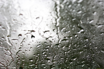 Surface of window with rain drops as background