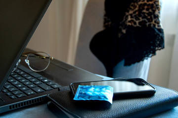Workplace in the office. On the chair is lingerie. Condom. Office tools..Office romance. Harassment