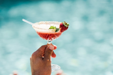 cropped view of man holding cocktail glass with alcohol drink