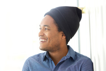 Close up handsome young african american man smiling and looking away