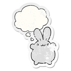 cartoon rabbit and thought bubble as a distressed worn sticker