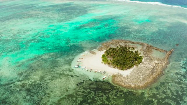 Travel concept: sandy beach on a small island by coral reef atoll from above. Guyam island, Philippines, Siargao. Summer and travel vacation concept.