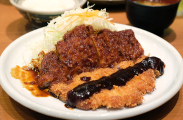 miso sauce top with tonkatsu on white dish