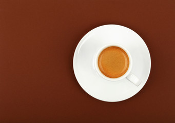 Full white espresso coffee cup over brown