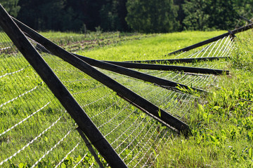 Broken metal chain fence.