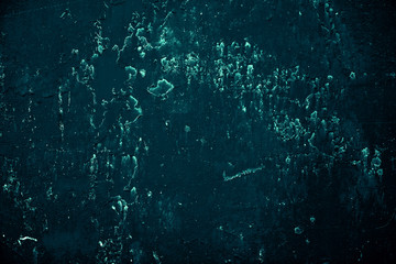 Vintage azure background. Rough painted wall of turquoise color. Imperfect plane of cyan colored. Uneven old decorative toned backdrop of aqzure tint. Texture of teal hue. Ornamental stony surface.