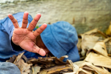 selective focus of Homeless dirty hand in abandoned house. Him He tried to raise his hand to prevent danger from physical abuse. concept for violence, terrified and Human Rights
