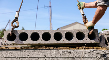 A crane raised a concrete slab at a construction site at home