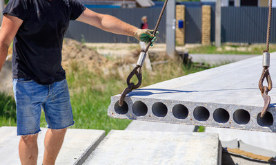 Installing concrete slabs at a construction site at home