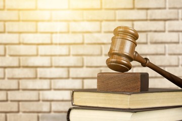 Books and wooden gavel on table. Justice concept