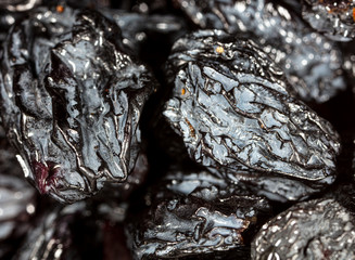 Black dry raisins as background